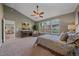 Bright primary bedroom with sitting area, vaulted ceilings, and ensuite bathroom at 6673 S Benton St, Littleton, CO 80123