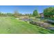 Scenic pond with lush landscaping, wooden bridge and tranquil water features at 6673 S Benton St, Littleton, CO 80123