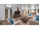Finished basement with neutral colors, plush seating, and a modern entertainment center at 153 S Pierce St, Lakewood, CO 80226