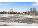 Outdoor basketball court with two hoops, partially covered in snow at 153 S Pierce St, Lakewood, CO 80226