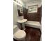 Clean bathroom with dark tile, pedestal sink, and bathtub at 153 S Pierce St, Lakewood, CO 80226