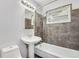 Clean bathroom with a pedestal sink and shower/tub combo at 153 S Pierce St, Lakewood, CO 80226