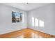 Bright bedroom with hardwood floors and large window at 153 S Pierce St, Lakewood, CO 80226