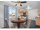 Cozy dining area with a round table, comfortable chairs, and a modern ceiling fan at 153 S Pierce St, Lakewood, CO 80226