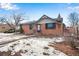 Brick ranch home with attached garage and snowy front yard at 153 S Pierce St, Lakewood, CO 80226