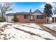 Brick ranch home with attached garage and snowy front yard at 153 S Pierce St, Lakewood, CO 80226