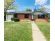 Charming brick home featuring a well-maintained front yard and a quaint entrance walkway at 153 S Pierce St, Lakewood, CO 80226