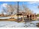Covered picnic area with tables near a frozen pond with trees and clear skies at 153 S Pierce St, Lakewood, CO 80226