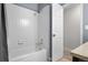 Clean bathroom with a tub and shower combination with white tile surround at 4301 S Pierce St # 6D, Littleton, CO 80123