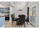 Cozy dining area with modern lighting, adjacent to updated kitchen and sliding glass doors at 4301 S Pierce St # 6D, Littleton, CO 80123