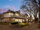 Charming exterior view of townhome with lush landscaping and warm lighting at dusk at 4301 S Pierce St # 6D, Littleton, CO 80123