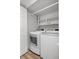Clean laundry area with updated, modern side-by-side washer and dryer, and shelving for storage at 4301 S Pierce St # 6D, Littleton, CO 80123