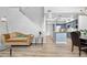 Inviting living room showcasing hardwood floors, a cozy couch, and open access to the kitchen at 4301 S Pierce St # 6D, Littleton, CO 80123