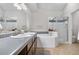 Ensuite bath includes a double vanity, a shower and soaking tub with tile surround at 4301 S Pierce St # 6D, Littleton, CO 80123