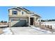 Two-story house with light-colored siding, a two-car garage, and a wooden fence at 210 Paloma Way, Elizabeth, CO 80107