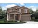 Two-story house with brown siding, stone accents, and a two-car garage at 210 Paloma Way, Elizabeth, CO 80107