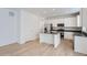 Modern kitchen with white cabinets, dark countertops, and a kitchen island at 210 Paloma Way, Elizabeth, CO 80107