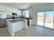 Modern kitchen with white cabinets, an island, and stainless steel appliances at 210 Paloma Way, Elizabeth, CO 80107