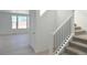 Modern staircase with black metal balusters leading to the second floor at 210 Paloma Way, Elizabeth, CO 80107