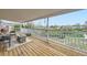 View from the covered balcony featuring a wooden deck, white railing, and furniture at 1146 Croke Dr, Thornton, CO 80260