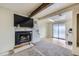 Cozy basement featuring a rustic fireplace and sliding glass doors to outside at 1146 Croke Dr, Thornton, CO 80260