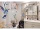 Cozy bathroom featuring a vanity, a standard showerhead, and a decorative hummingbird shower curtain at 1146 Croke Dr, Thornton, CO 80260