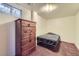 Small carpeted bedroom features a low bed, wood dresser and a window at 1146 Croke Dr, Thornton, CO 80260