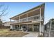 Exterior view of home with expansive two-story deck and storage at 1146 Croke Dr, Thornton, CO 80260