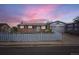 Charming brick home featuring a cozy front yard with a white picket fence and a convenient garage at 1146 Croke Dr, Thornton, CO 80260
