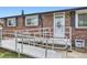 Close-up shot of a red brick home featuring a disability ramp leading to the front door at 1146 Croke Dr, Thornton, CO 80260
