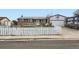 Charming single-story brick home with a white picket fence and well-manicured lawn at 1146 Croke Dr, Thornton, CO 80260