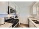 Modern kitchen with stainless steel appliances, white cabinets, and granite countertops at 1146 Croke Dr, Thornton, CO 80260
