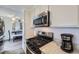 This kitchen features modern appliances, granite countertops and white cabinetry at 1146 Croke Dr, Thornton, CO 80260