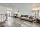 Cozy living room open to the dining area, featuring modern flooring and plenty of natural light at 1146 Croke Dr, Thornton, CO 80260