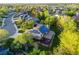 Aerial view of home with solar panels nestled in lush green landscape with mature trees at 10188 Stephen Pl, Highlands Ranch, CO 80130