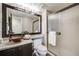 Stylish bathroom boasts a copper vessel sink, granite countertop, and walk-in shower at 10188 Stephen Pl, Highlands Ranch, CO 80130