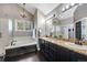Bathroom with dark cabinets, granite countertops, a chandelier and separate tub and shower at 10188 Stephen Pl, Highlands Ranch, CO 80130