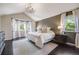 This bedroom has a large bed, dark wood flooring, and lots of natural light at 10188 Stephen Pl, Highlands Ranch, CO 80130