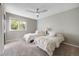 This bedroom has two beds, a ceiling fan, and a neutral color palette at 10188 Stephen Pl, Highlands Ranch, CO 80130