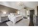 This bedroom has a large bed, dark wood flooring, and lots of natural light at 10188 Stephen Pl, Highlands Ranch, CO 80130