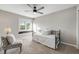 Cozy bedroom featuring a daybed, accent chair, and a view of the outdoors at 10188 Stephen Pl, Highlands Ranch, CO 80130