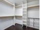 Walk in closet with lots of storage space and dark wood flooring at 10188 Stephen Pl, Highlands Ranch, CO 80130
