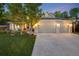 Charming brick home boasts a spacious three-car garage and beautifully landscaped front yard at 10188 Stephen Pl, Highlands Ranch, CO 80130