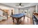 Well-lit game room featuring a classic pool table and ample space for entertaining at 10188 Stephen Pl, Highlands Ranch, CO 80130