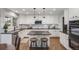 Updated eat-in kitchen features a center island, black countertops, and stainless steel appliances at 10188 Stephen Pl, Highlands Ranch, CO 80130