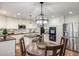 Well-lit kitchen features white cabinets, stainless steel appliances, and an island at 10188 Stephen Pl, Highlands Ranch, CO 80130