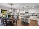 Bright eat-in kitchen features a center island, white cabinets, and modern stainless steel appliances at 10188 Stephen Pl, Highlands Ranch, CO 80130