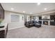 Comfortable living room featuring a dark sofa, fireplace and wet bar for relaxing and entertaining at 10188 Stephen Pl, Highlands Ranch, CO 80130