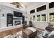 Cozy living room with a brick fireplace and large windows offering serene views at 10188 Stephen Pl, Highlands Ranch, CO 80130