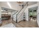 Elegant staircase with dark wood and white railings leading to the upper level at 10188 Stephen Pl, Highlands Ranch, CO 80130